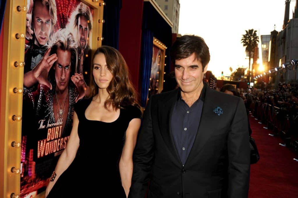 David Copperfield walks with wife Chloe Gosselin at the Premiere of Warner Bros. Pictures The Incredible Burt Wonderstone - Red Carpet